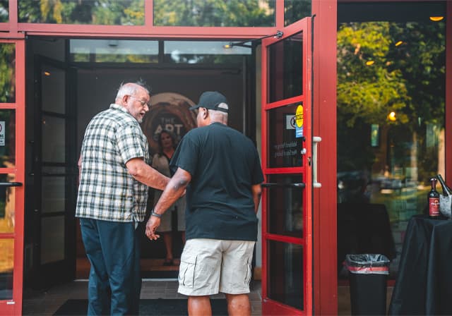 Men walking into Quincy Art Center front doors