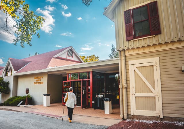 Woman walking to front door of Quincy Art Center